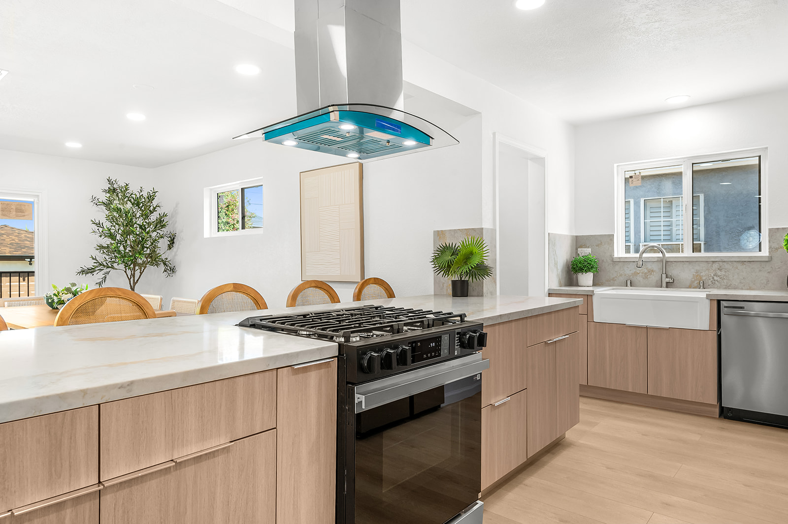 Waterfall quartz island with curved-glass range hood